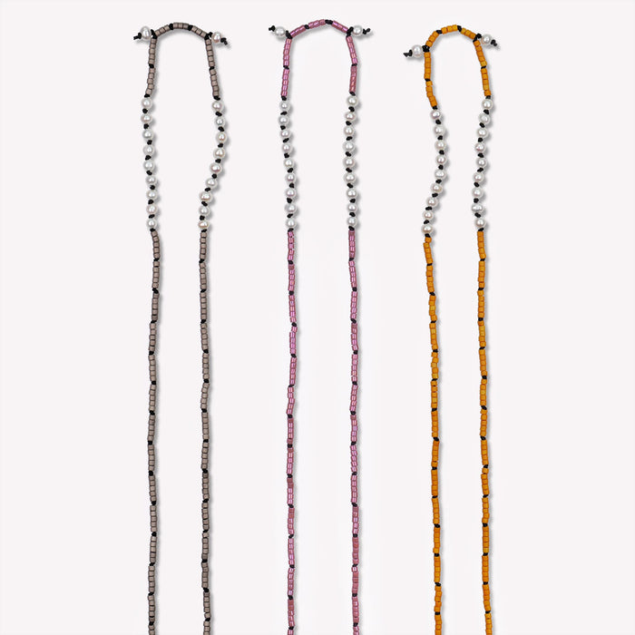 Freshwater Pearl Sawyer Pullover Necklace. Set 1.3. Hand-knotted with glass beads on black silk cord. Available colors shown are Graphite Gray, Golden Rhubarb and Sienna Brown. $165 each. 23 inches in length. Detailed image of top half.